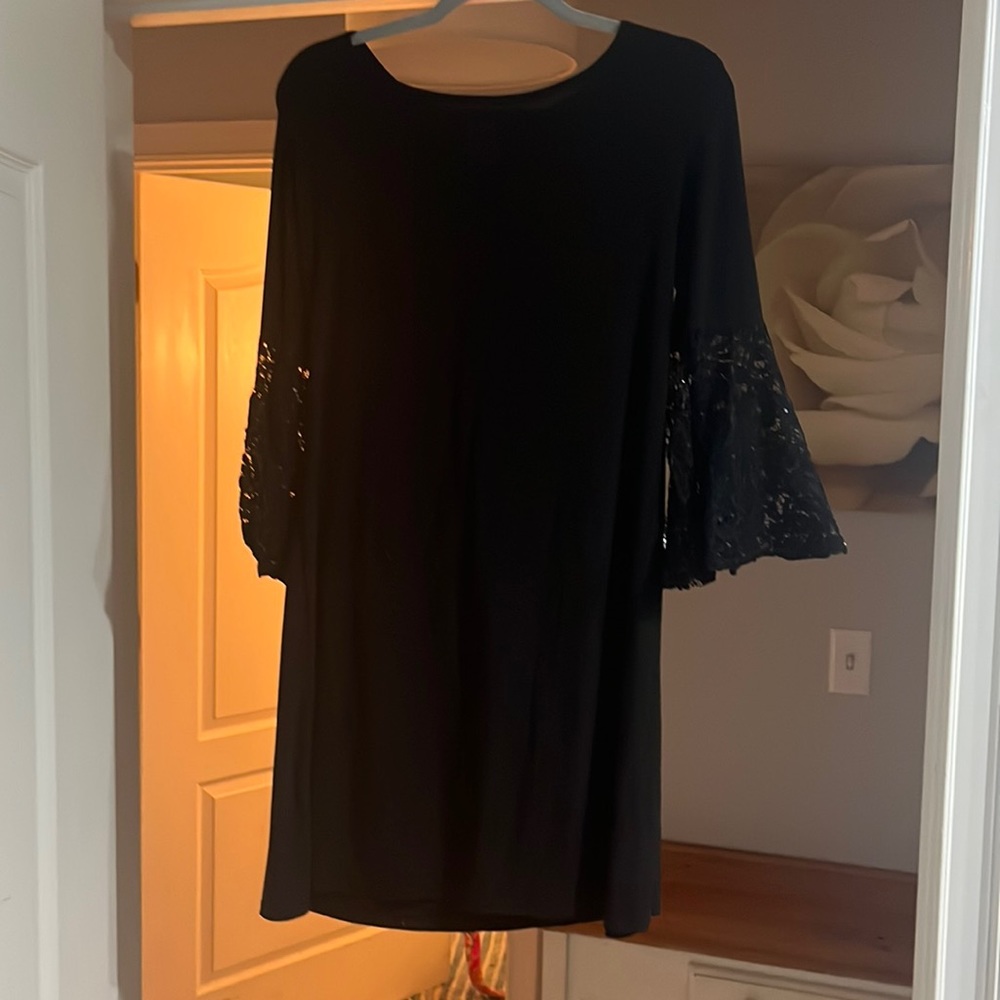 Black dress with sparkle trumpet sleeves.